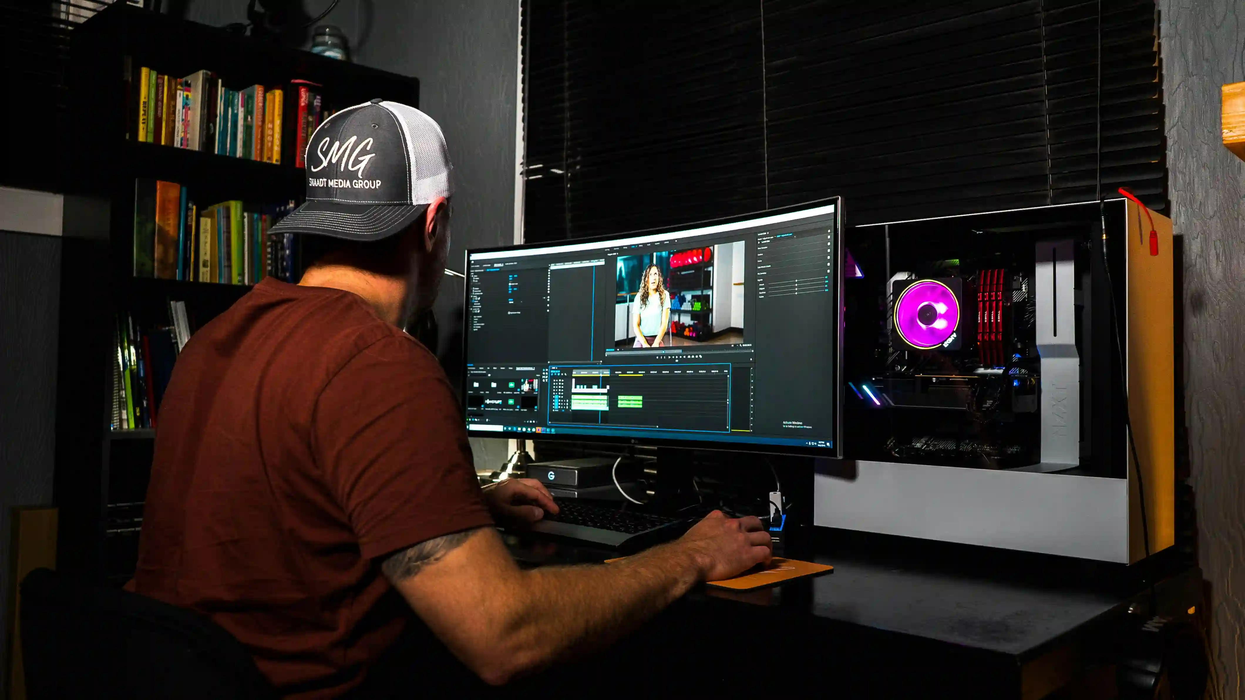 A person editing a video on a large monitor